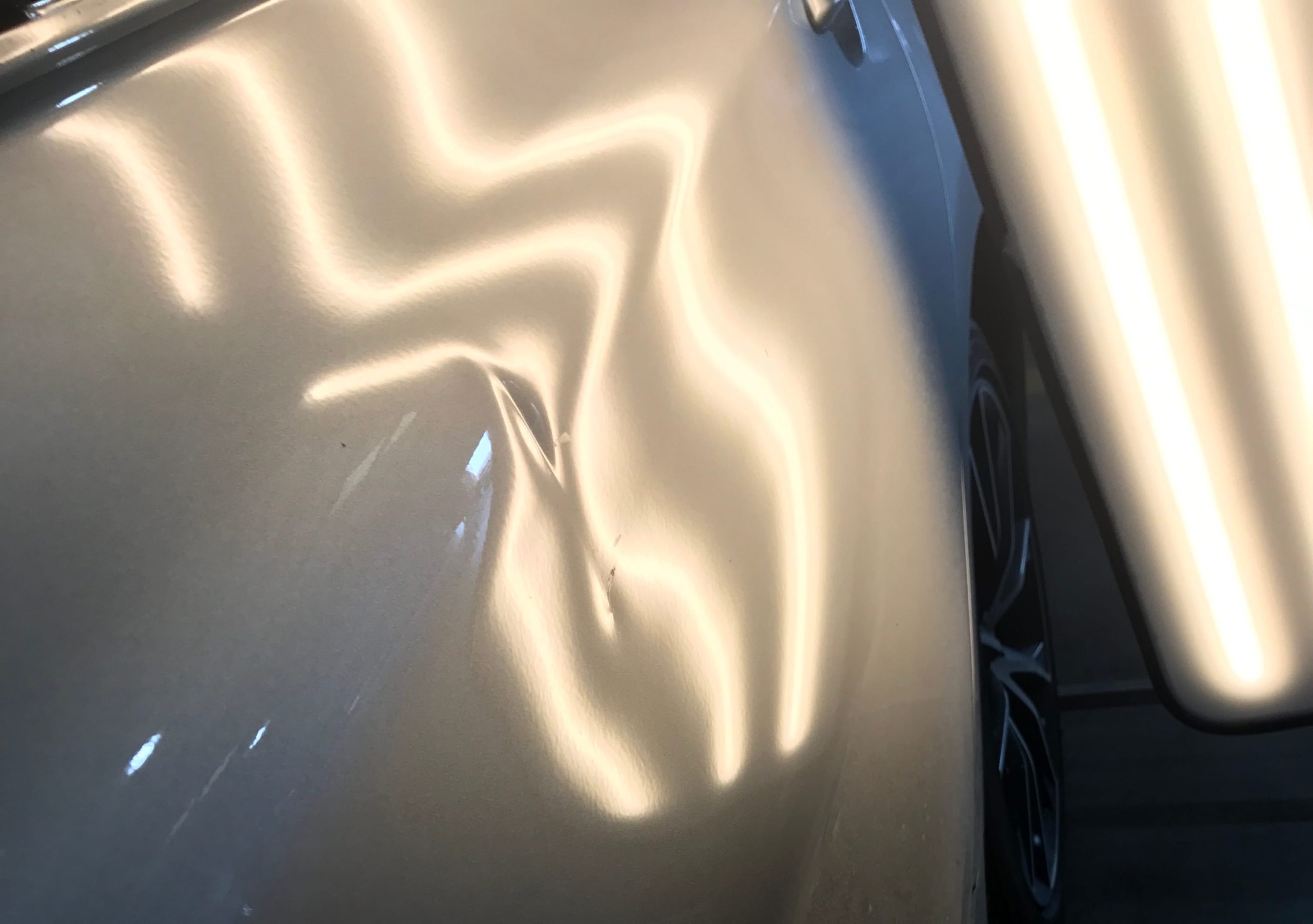 Before: Deep panel dent restored to factory condition