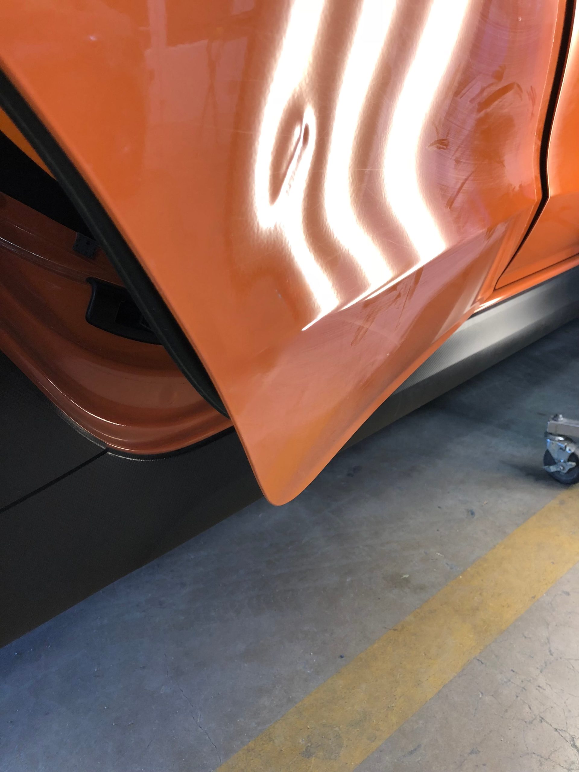 Before: Door panel dent removed with precision PDR techniques