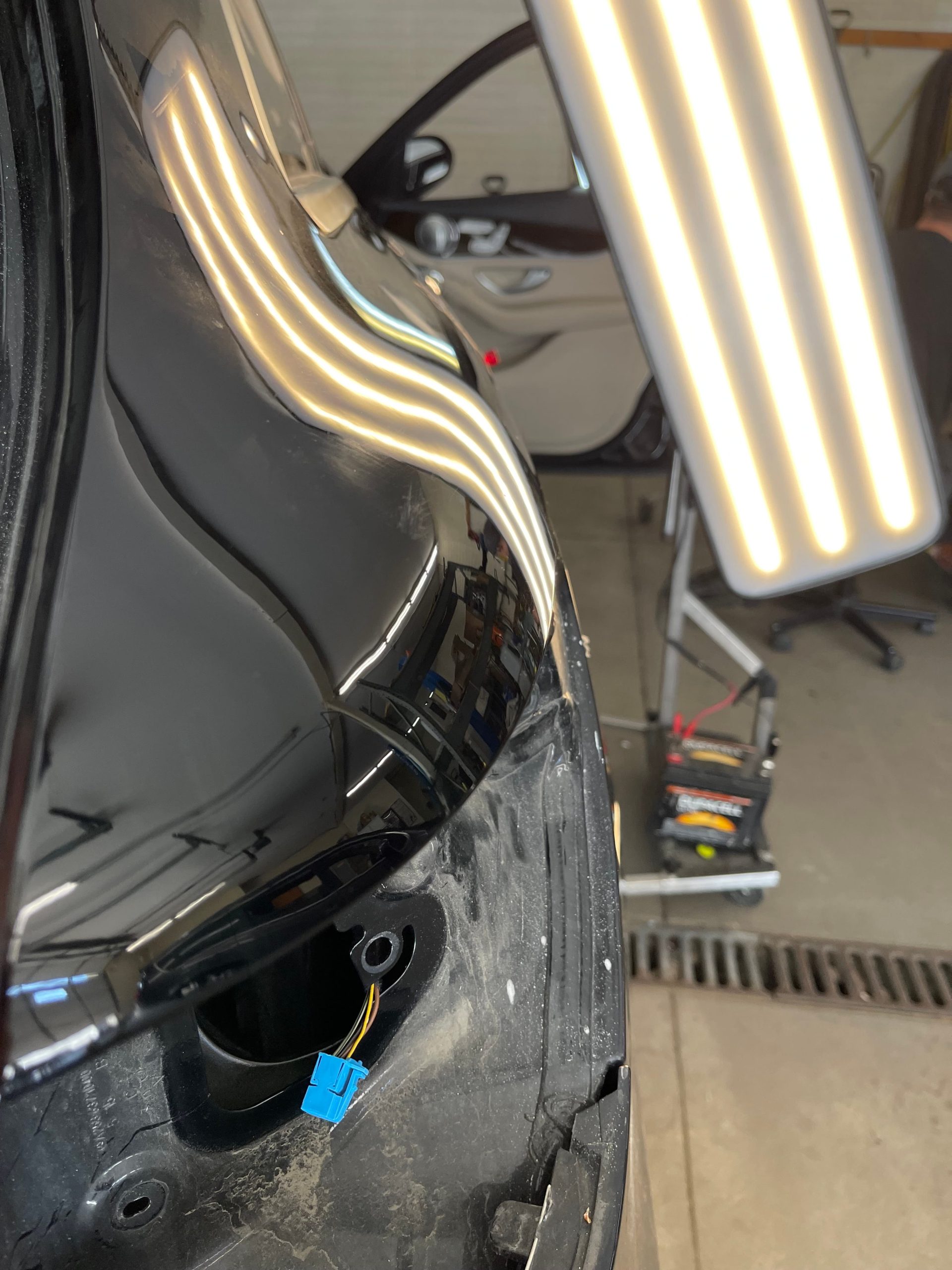 After: Fender dent restored to smooth factory finish